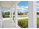 Spacious covered porch with white support columns offers views of a manicured lawn and quiet street at 2199 Broadbrook Drive, St Cloud, FL 34771