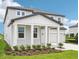Stylish two-story home with covered porch, two-car garage, and manicured landscaping at 2199 Broadbrook Drive, St Cloud, FL 34771