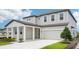 Attractive two-story home with a spacious two-car garage, covered porch, and green lawn at 2199 Broadbrook Drive, St Cloud, FL 34771