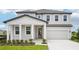 Charming two-story home with landscaped yard, covered porch, and attached two-car garage at 2199 Broadbrook Drive, St Cloud, FL 34771
