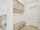 Hallway featuring a built-in bench and storage cabinets with a doorway to the outside at 2199 Broadbrook Drive, St Cloud, FL 34771