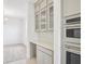 Butler's pantry with upper glass door cabinets plus stainless appliances at 2199 Broadbrook Drive, St Cloud, FL 34771