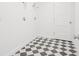Functional laundry room features checkered flooring and hookups for modern appliances at 2199 Broadbrook Drive, St Cloud, FL 34771