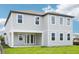 This two-story home features gray siding, white trim, a covered patio, and plentiful windows for natural light at 2199 Broadbrook Drive, St Cloud, FL 34771