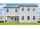 This home's rear exterior includes gray siding, white trim, a covered patio, and bright, natural light from the windows at 2199 Broadbrook Drive, St Cloud, FL 34771