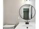 A remodeled bathroom with updated vanity, fixtures, lighting, and round mirror at 2902 Wheeler St, Bartow, FL 33830