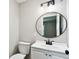 A remodeled bathroom with updated vanity, fixtures, lighting, and round mirror at 2902 Wheeler St, Bartow, FL 33830