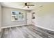 Bedroom featuring wood-look flooring, a ceiling fan, and a view through the window at 2902 Wheeler St, Bartow, FL 33830