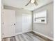 Bright bedroom with gray wood floors, closet, ceiling fan, and a window for natural light at 2902 Wheeler St, Bartow, FL 33830