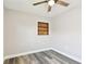 A bright bedroom with gray wood floors, a ceiling fan, and a built-in wall shelf at 2902 Wheeler St, Bartow, FL 33830