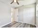 Bright bedroom with gray wood floors, closet, ceiling fan, and a window for natural light at 2902 Wheeler St, Bartow, FL 33830
