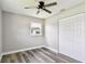 Bright bedroom with gray wood floors, closet, ceiling fan, and a window for natural light at 2902 Wheeler St, Bartow, FL 33830