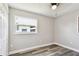 Bright bedroom with gray wood floors, closet, ceiling fan, and a window for natural light at 2902 Wheeler St, Bartow, FL 33830