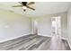 Large bedroom featuring wood-look floors, a ceiling fan, and access to an ensuite bathroom at 2902 Wheeler St, Bartow, FL 33830