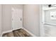 Entryway with a white front door, wood-look flooring, and an open doorway to a bedroom at 2902 Wheeler St, Bartow, FL 33830