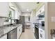 Modern kitchen featuring granite countertops, stainless steel appliances, and sleek white cabinets at 2902 Wheeler St, Bartow, FL 33830