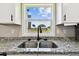 Close-up of stainless steel sink with granite countertops, overlooking the backyard at 2902 Wheeler St, Bartow, FL 33830