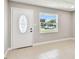 Inviting living space with a decorative front door and a window providing natural light, set against neutral walls at 2902 Wheeler St, Bartow, FL 33830