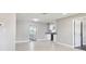 Open-concept living space with tile flooring, neutral paint, and an open door to the modernized kitchen at 2902 Wheeler St, Bartow, FL 33830