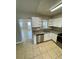 Stylish kitchen with white cabinets and granite counters, open to adjacent living areas at 3802 Bryston Dr, Orlando, FL 32822