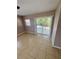 Bright living room features tile flooring and sliding glass doors to the backyard at 3802 Bryston Dr, Orlando, FL 32822