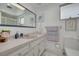 Bright bathroom featuring a sleek mirror, stylish accents, and a combination tub and shower at 21078 Sw Honeysuckle St, Dunnellon, FL 34431
