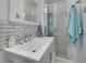 Modern bathroom with a glass shower, white vanity, and stylish subway tile at 21078 Sw Honeysuckle St, Dunnellon, FL 34431