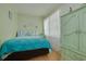Cozy bedroom with natural light, complemented by an antique green wardrobe at 21078 Sw Honeysuckle St, Dunnellon, FL 34431