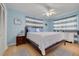 Light and airy bedroom with pale blue walls, white furniture, and a ceiling fan at 21078 Sw Honeysuckle St, Dunnellon, FL 34431