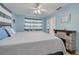 Comfortable bedroom with blue walls, striped curtains, and a brick fireplace at 21078 Sw Honeysuckle St, Dunnellon, FL 34431