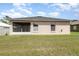 A huge backyard with a manicured lawn and views of the back of the house at 3235 Grand Pines Dr, Lakeland, FL 33810