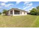 A huge backyard with a manicured lawn and views of the back of the house at 3235 Grand Pines Dr, Lakeland, FL 33810