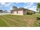 A huge backyard with a manicured lawn and views of the back of the house at 3235 Grand Pines Dr, Lakeland, FL 33810