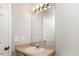 Well-lit bathroom featuring a sink, mirror, and vanity with a neutral color palette at 3235 Grand Pines Dr, Lakeland, FL 33810