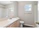 Well-lit bathroom with wood cabinets, a large mirror, and a shower/tub combo at 3235 Grand Pines Dr, Lakeland, FL 33810