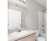 Well-lit bathroom with wood cabinets, a large mirror, and a shower/tub combo at 3235 Grand Pines Dr, Lakeland, FL 33810