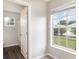 View from a bedroom, featuring a window with a view, and a doorway to an attached bathroom at 3235 Grand Pines Dr, Lakeland, FL 33810