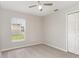 Neutral bedroom featuring plush carpeting, a closet, and a window with a view at 3235 Grand Pines Dr, Lakeland, FL 33810