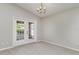Cozy dining room featuring carpeted floors, French doors, and a chandelier at 3235 Grand Pines Dr, Lakeland, FL 33810