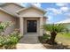 Welcoming entryway featuring a dark front door, decorative columns, and a well-manicured front yard at 3235 Grand Pines Dr, Lakeland, FL 33810