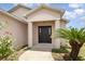 Close up of the entryway featuring a solid door, decorative columns and plants nearby at 3235 Grand Pines Dr, Lakeland, FL 33810