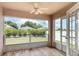 Relaxing Florida room with tile floors, screen windows with backyard views, and ceiling fan at 3235 Grand Pines Dr, Lakeland, FL 33810