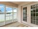 Relaxing Florida room with tile floors, screen windows with backyard views, and ceiling fan at 3235 Grand Pines Dr, Lakeland, FL 33810
