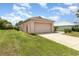 Detached one car garage, set back from the home with a paved driveway and grassy side yard at 3235 Grand Pines Dr, Lakeland, FL 33810