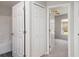 Hallway with a closet and doorways to an attached bathroom and a bedroom at 3235 Grand Pines Dr, Lakeland, FL 33810