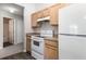 Well-lit kitchen featuring white appliances, wooden cabinets, and practical countertops at 3235 Grand Pines Dr, Lakeland, FL 33810