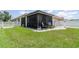 The home has a well-maintained lawn with a screened patio and a privacy fence at 3321 Pintello Ave, New Smyrna Beach, FL 32168
