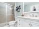 Bathroom featuring a shower with glass door, a white vanity, and modern fixtures at 3321 Pintello Ave, New Smyrna Beach, FL 32168