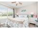Bedroom with a ceiling fan, a window view, and furniture at 3321 Pintello Ave, New Smyrna Beach, FL 32168