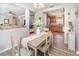 Open dining area with wood floors, light walls, and an open view to the kitchen and living area at 3321 Pintello Ave, New Smyrna Beach, FL 32168